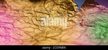 Crumpled torn golden bronze foil texture background Stock Photo