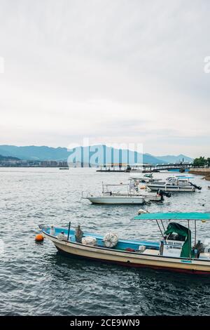 A vertical shot of boats parked at the dock on clear sky background in ...