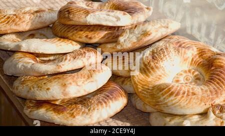 Typical traditional flatbread with crunchy crust with sesam just baked in tandoor on market display of old bakery. Fresh yammy flavored bread Stock Photo
