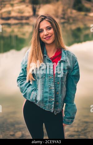Attractive Woman standing in nature Stock Photo