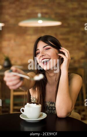 Young lady in cafe making grimace Stock Photo