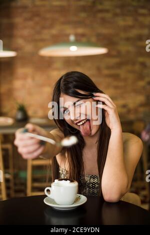 Young lady in cafe making grimace Stock Photo
