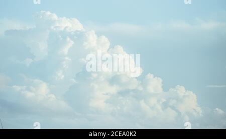 View of beautiful white cumulus clouds in blue sky with sunlight, Spain Stock Photo