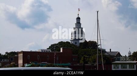 Maryland State house (State Capitol) building in Annapolis. image features the iconic tower with Maryland flag on it. image was taken from the marina Stock Photo