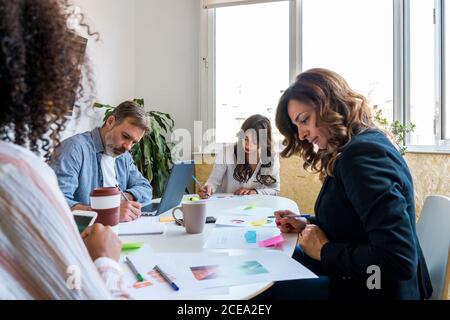 Colleagues communicating during work Stock Photo