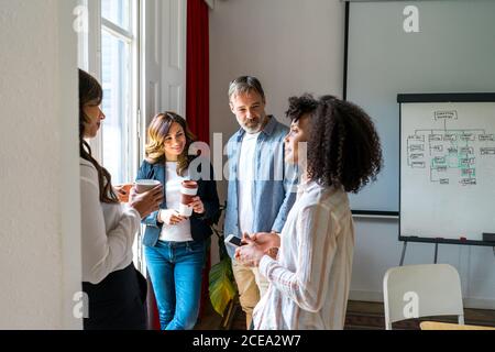 Colleagues talking near window Stock Photo