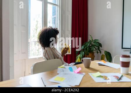 Woman sitting in conference room with laptop Stock Photo