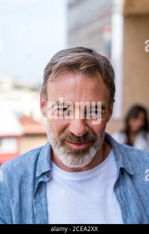 Bearded adult male with wrinkles smiling Stock Photo