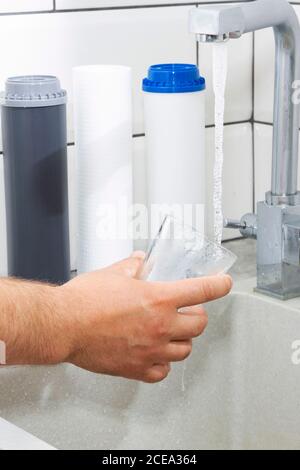 The tap from which water flows. Quenching thirst. Water problems in some countries.The glass is filled with water. Stock Photo