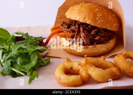 Sweet bun barbecue beef brisket with watercress leaves. Whisky barrel chip smoked British beef brisket with smoky barbecue sauce Stock Photo