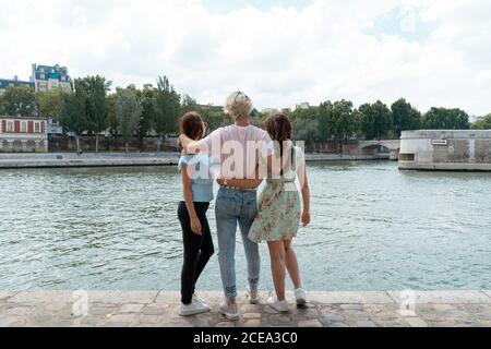 Smiling friends standing on waterfront Stock Photo