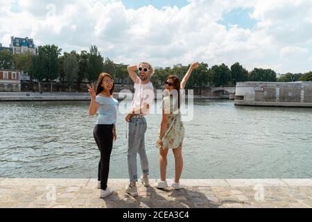 Smiling friends standing on waterfront Stock Photo
