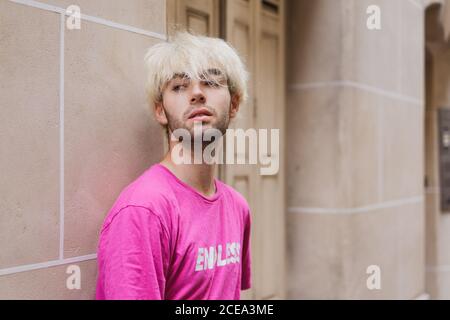 Stylish man standing near window Stock Photo