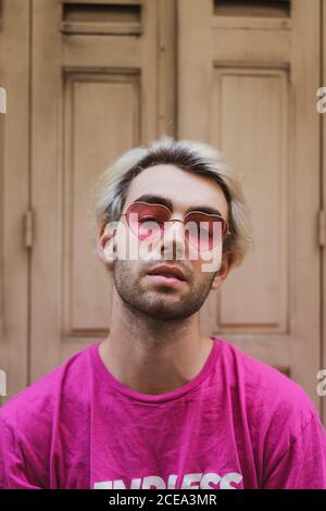 Stylish man sitting on window sill Stock Photo