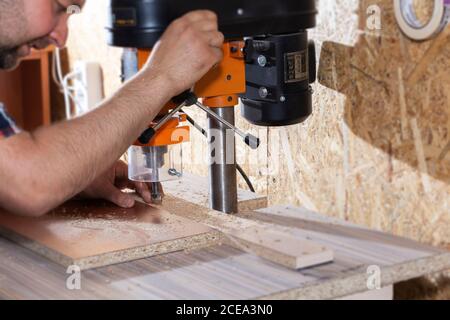 Drill in the drilling machine, making furniture Stock Photo