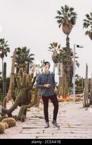 Young man posing at cactus Stock Photo