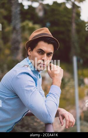 Thoughtful man leaning on handrail Stock Photo