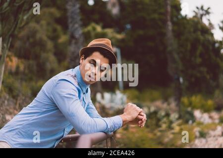 Thoughtful man leaning on handrail Stock Photo