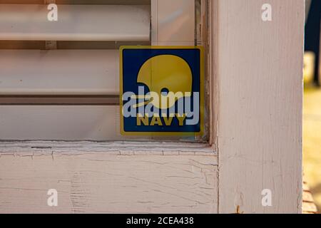 Annapolis, MD 08/21/2020: A close up isolated window sticker of United States Naval Academy Football Team on the door of a house in Annapolis. The tea Stock Photo