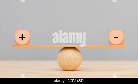 plus and minus in balance Stock Photo