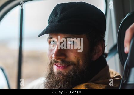 Handsome bearded man smiling and looking at camera while traveling through Iceland in car. Stock Photo