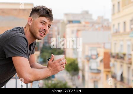 Relaxing man having coffee on balcony Stock Photo