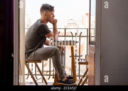 man using laptop outdoors Stock Photo