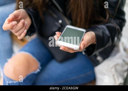 Lady using smartphone near Woman Stock Photo