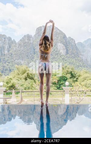 Attractive Woman in bikini at poolside Stock Photo