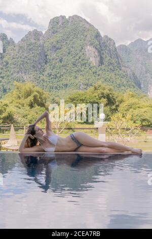 Woman in a turquoise bikini is lying at the swimming pool Stock Photo ...