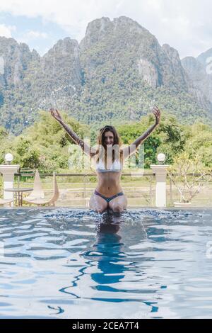 Attractive Woman in bikini at poolside Stock Photo