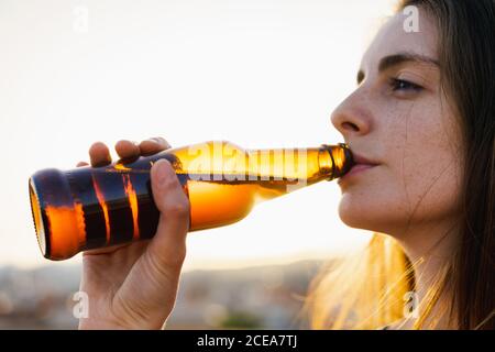 Happy Woman holding brown glass bottle Stock Photo