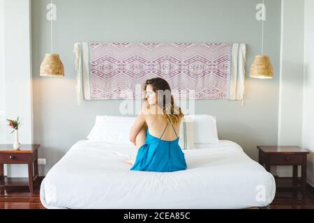 Woman sitting on bed Stock Photo