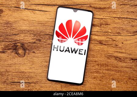 WETZLAR, GERMANY 2020-03-27 HUAWEI LOGO on a cellphone screen. Top view on wooden background. Stock Photo