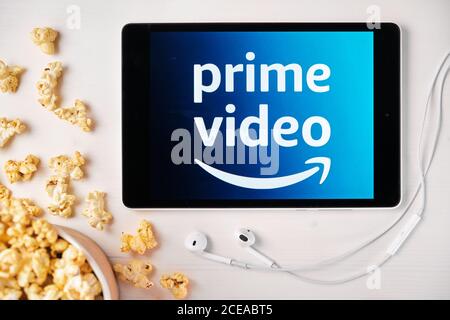 Amazon Prime Video Logo On The Screen Of The Tablet Laying On The White Table And Sprinkled Popcorn On It Apple Earphones Near The Tablet August Stock Photo Alamy