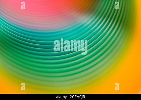 Closeup bright multicolored lines of lovely slinky toy Stock Photo