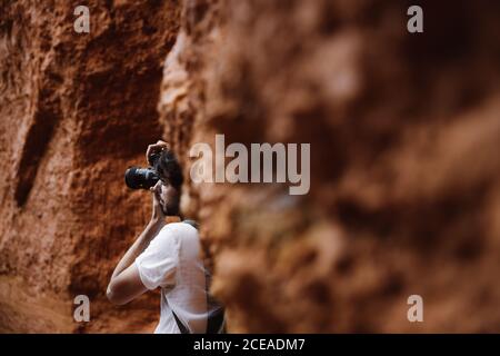 Side view if crop man with camera doing photo in rocky mountains in Cantabria, Spain Stock Photo