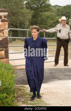 Luling, TX June 3, 2008: Gonzales County Deputy Bobby Hand refuses entry to a member of a polygamist FLDS sect  whose child was being held by the State of Texas at the Baptist Children's Youth Ranch. The woman arrived to pick up her child after a court ordered the sect members' children released into their parents' custody. She was later let in to pick up her child. ©Bob Daemmrich Stock Photo