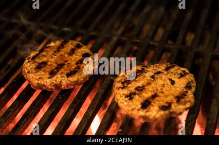 Closeup yummy patties roasting on hot grating of barbecue grill Stock Photo