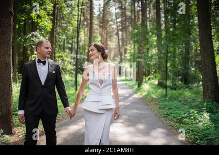 Married couple looking at each other in forest Stock Photo