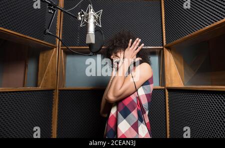 Young Woman singing in studio Stock Photo