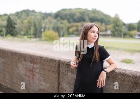 Young stylish Woman in black dress outdoors Stock Photo