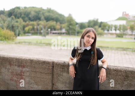 Young stylish Woman in black dress outdoors Stock Photo