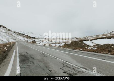 Snowy route running between mountains in Pyrenees Stock Photo