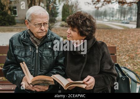 Senior couple reading books in park Stock Photo