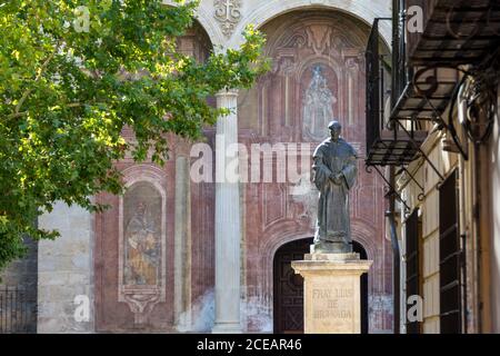 Statue of Fray Luis de Granada with the church of Santo Domingo behind in Granada (Spain) Stock Photo