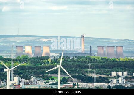 Fiddlers Ferry Power Station in Warrington, Cheshire seen from Helsby Hill, Frodsham, with wind turbine in foreground. Energy, industry, electricity, Stock Photo