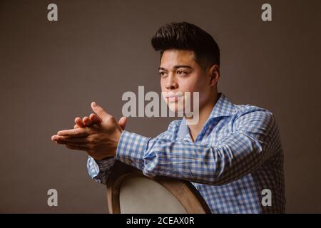 Handsome male posing on chair Stock Photo