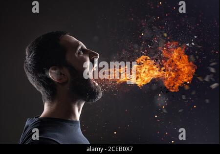 Stressed man screams with fire and smoke that exit from the mouth Stock Photo