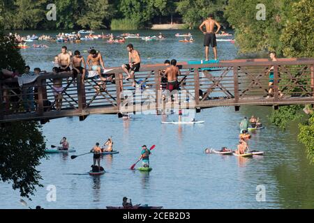 Young people eager to get outdoors during the coronavirus pandemic ignore social distancing guidelines to have fun in the cool waters of Barton Creek south of downtown Austin. ©Bob Daemmrich Stock Photo